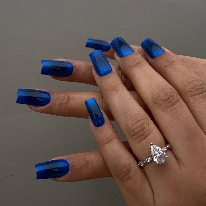 Dark blue nails are an on-trend holiday nail polish color for 2023.