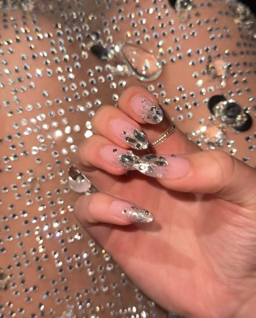 On Dec. 11, Sydney Sweeney arrived on the “Anyone But You” premiere red carpet with mismatched silve…