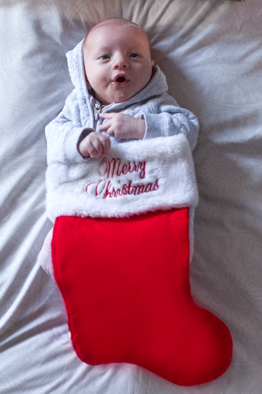 Baby inside a large Christmas stocking.