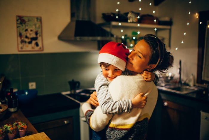 single mom and son hugging in kitchen at Christmas