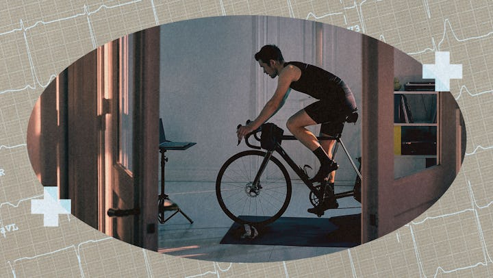 A man cycling on a stationary bike at home.