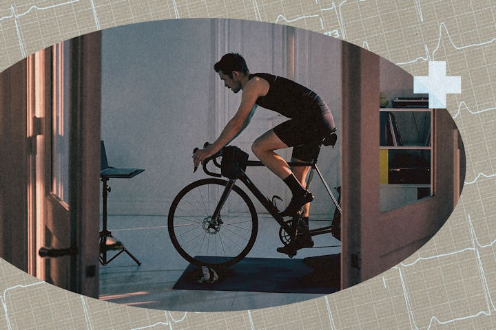 A man cycling on a stationary bike at home.