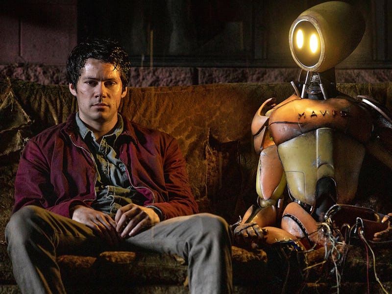 Dylan O'Brien sits with a robot in 'Love and Monsters'