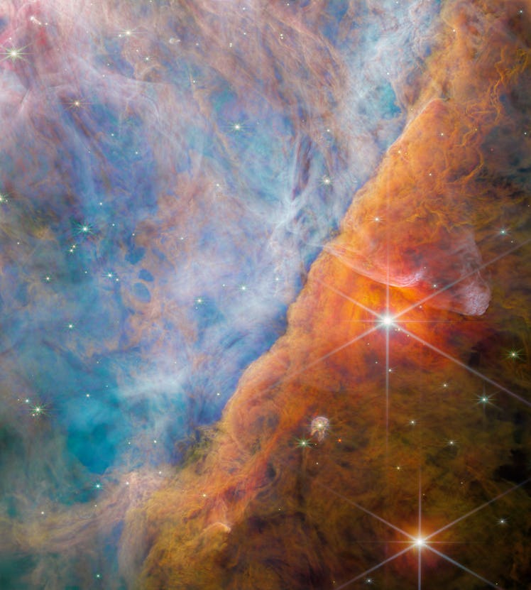  A nebula made of many layers of cloudy, colourful material. The top-left side of the image is brigh...