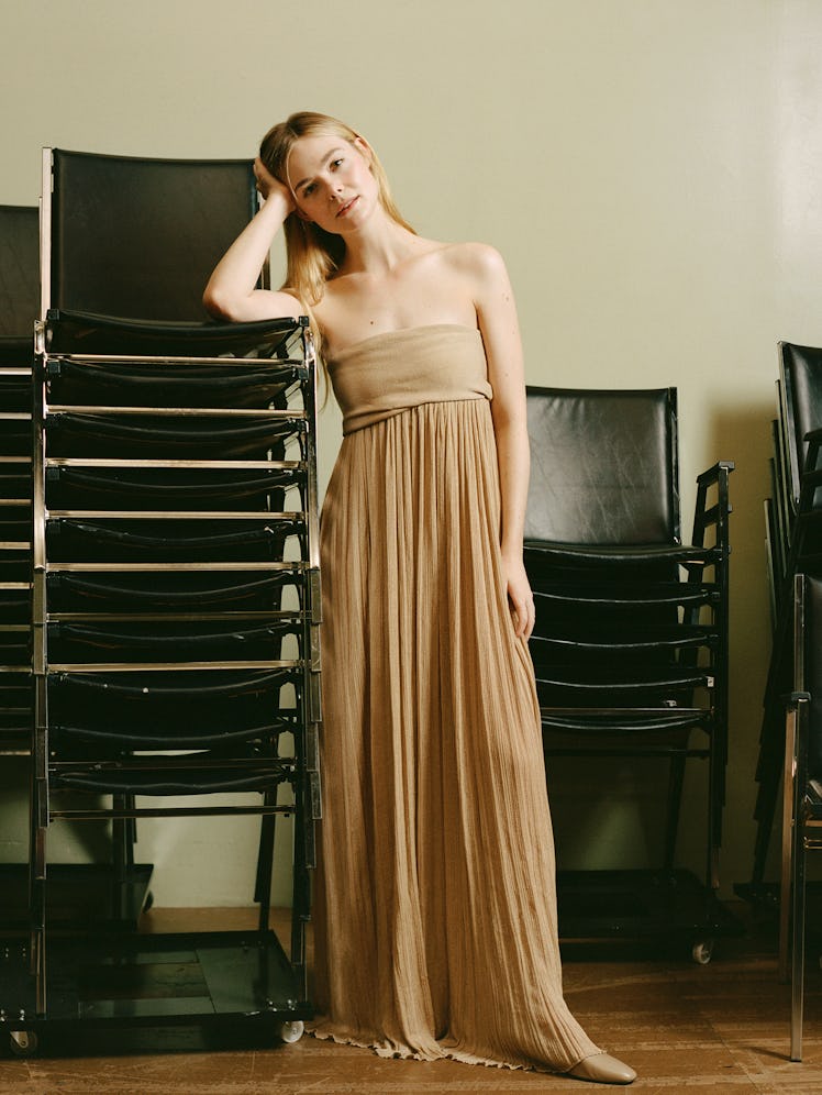Elle Fanning wears Proenza Schouler dress; The Row shoes.