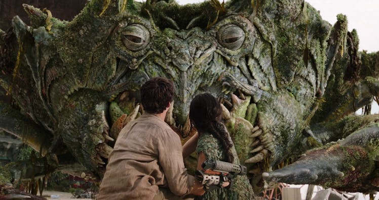 Dylan O'Brien and Jessica Henwick look up at a giant green crab in 'Love and Monsters'