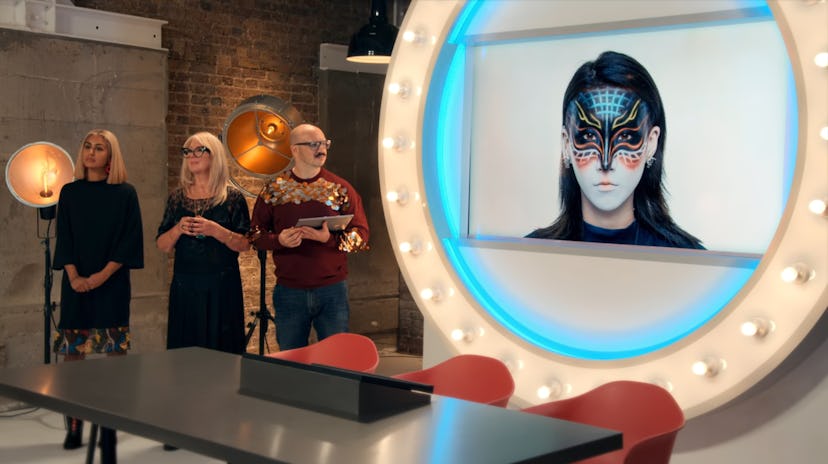 The 'Glow Up' judges critique a contestant's makeup look.