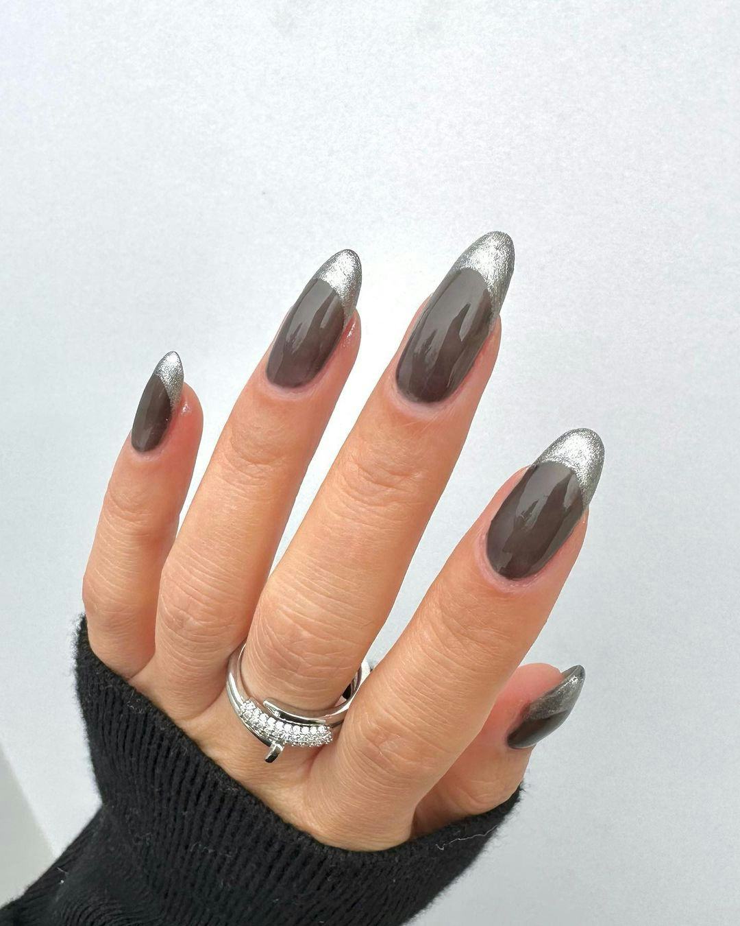Sheer black nails with silver French tips are a simple manicure design idea for New Year&rsquo;s Eve 2023 &hellip;