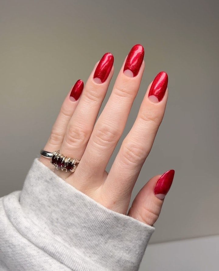 Red velvet half moon nails are a simple &amp; classy manicure design idea for New Year&rsquo;s Eve 2023 nails.