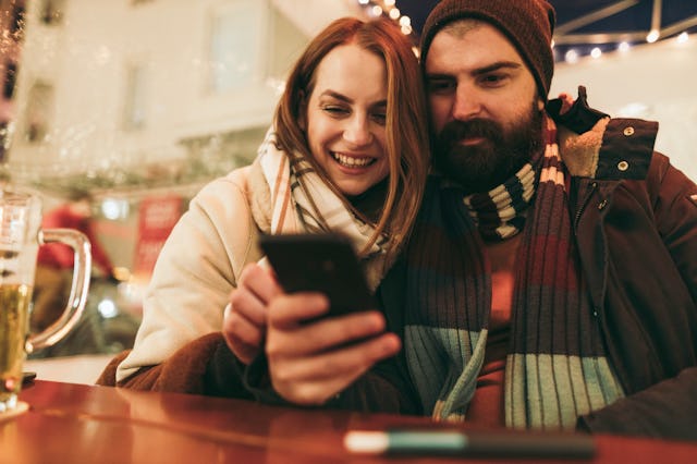 A couple takes a picture together over the holidays.