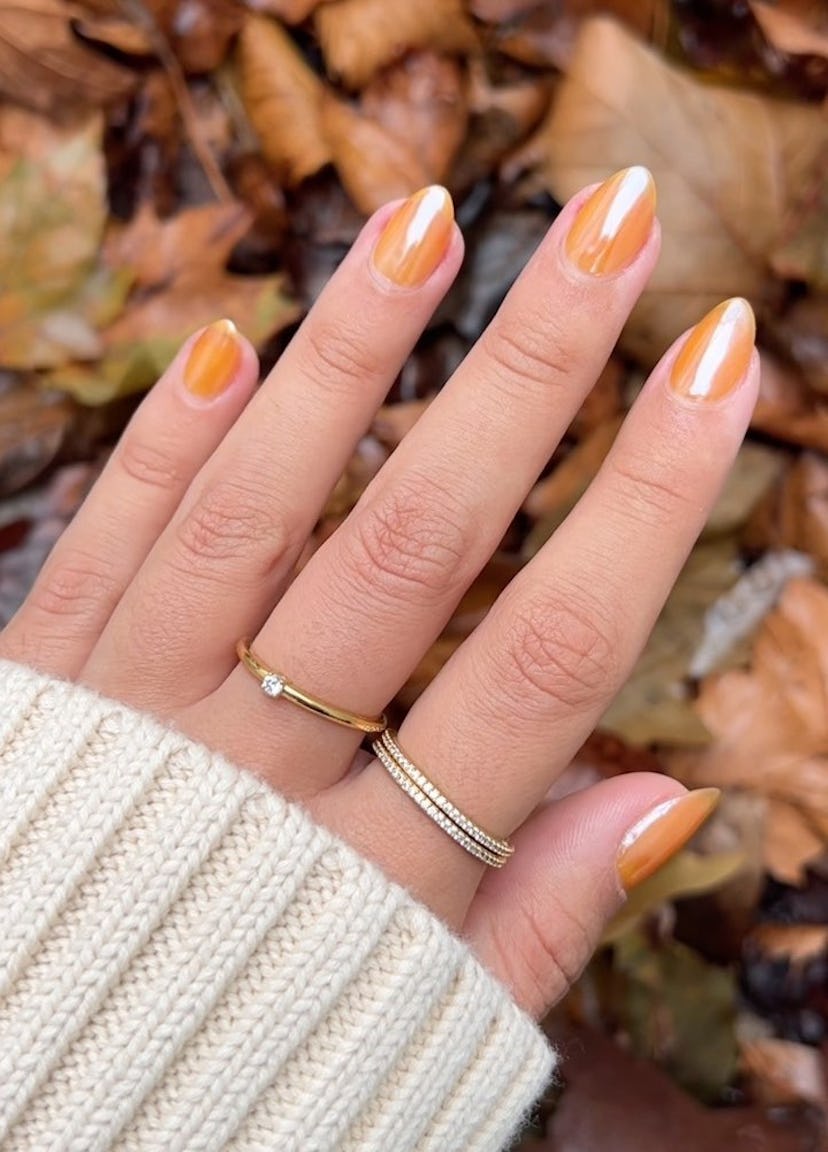 Peach chrome nails are an on-trend peach fuzz nail design for 2024.