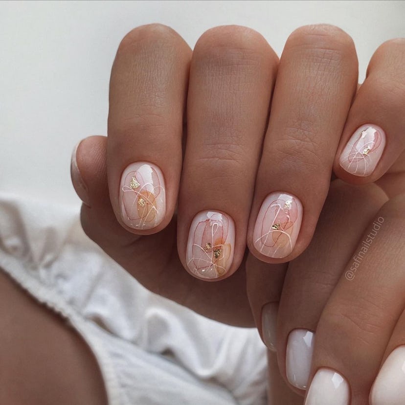 Abstract flower designs are an on-trend peach fuzz nail design for 2024.