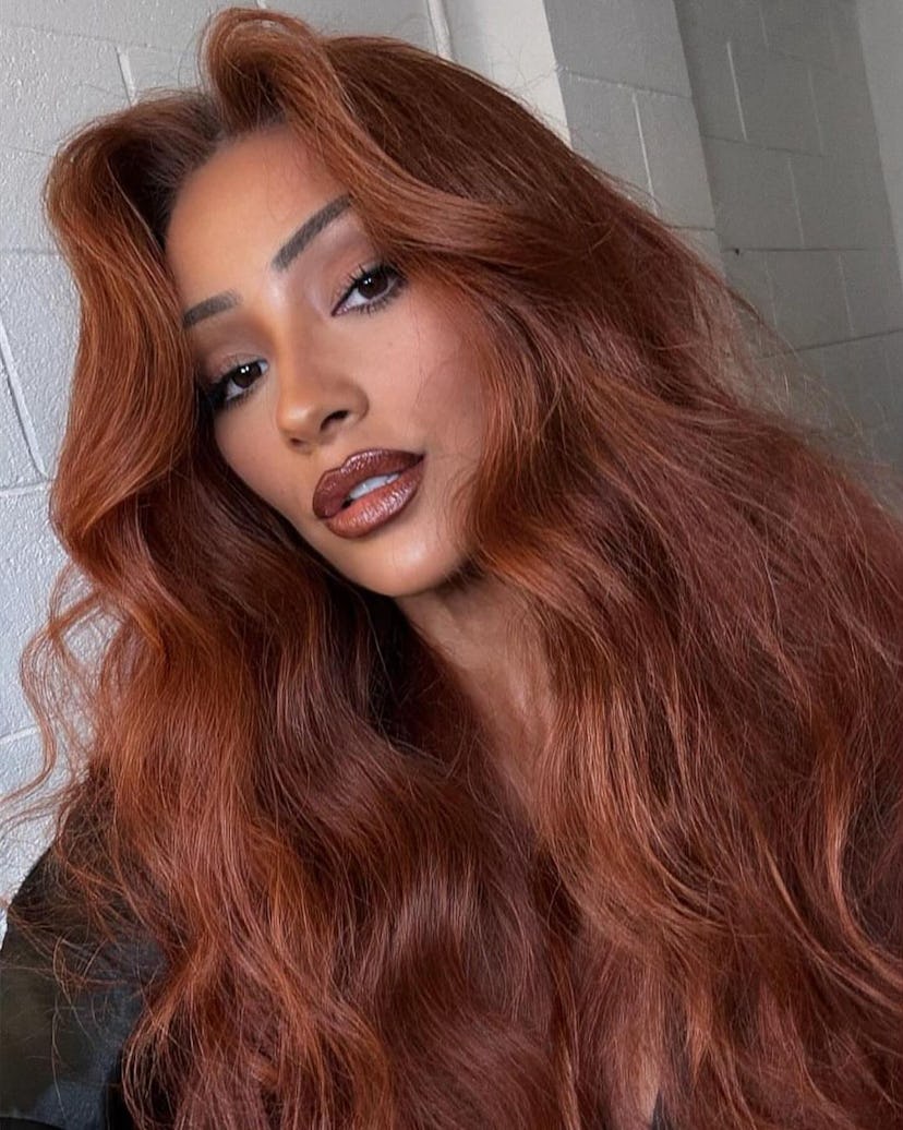 Shay Mitchell’s cowgirl copper hair is a popular winter hair color trend for 2024.