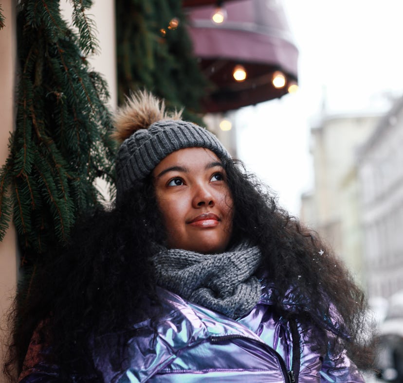 Young woman looking at snow outside during the December 2023 Cold Moon.