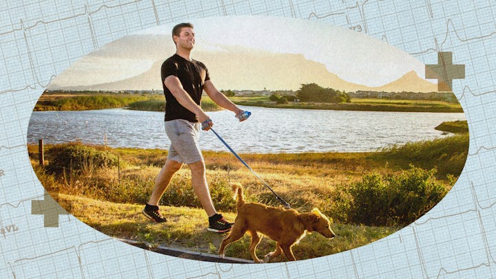 A man walking his dog by a lake.