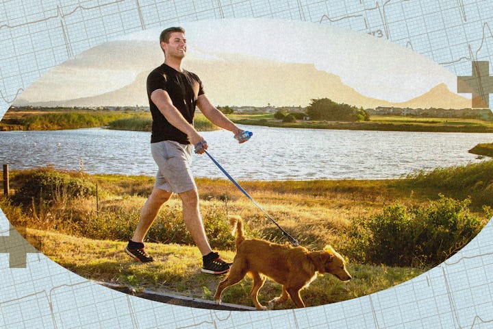 A man walking his dog by a lake.