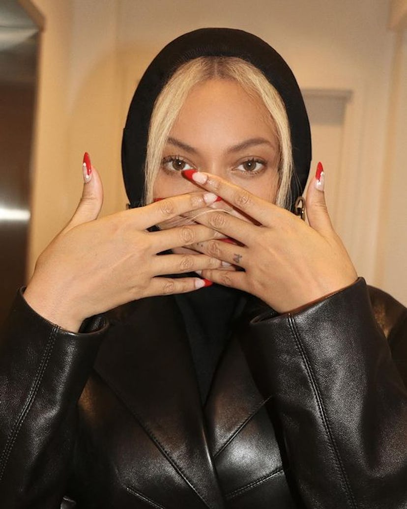 Beyoncé's Santa Claus hat red French tip nails are an on-trend manicure for Christmas 2023.