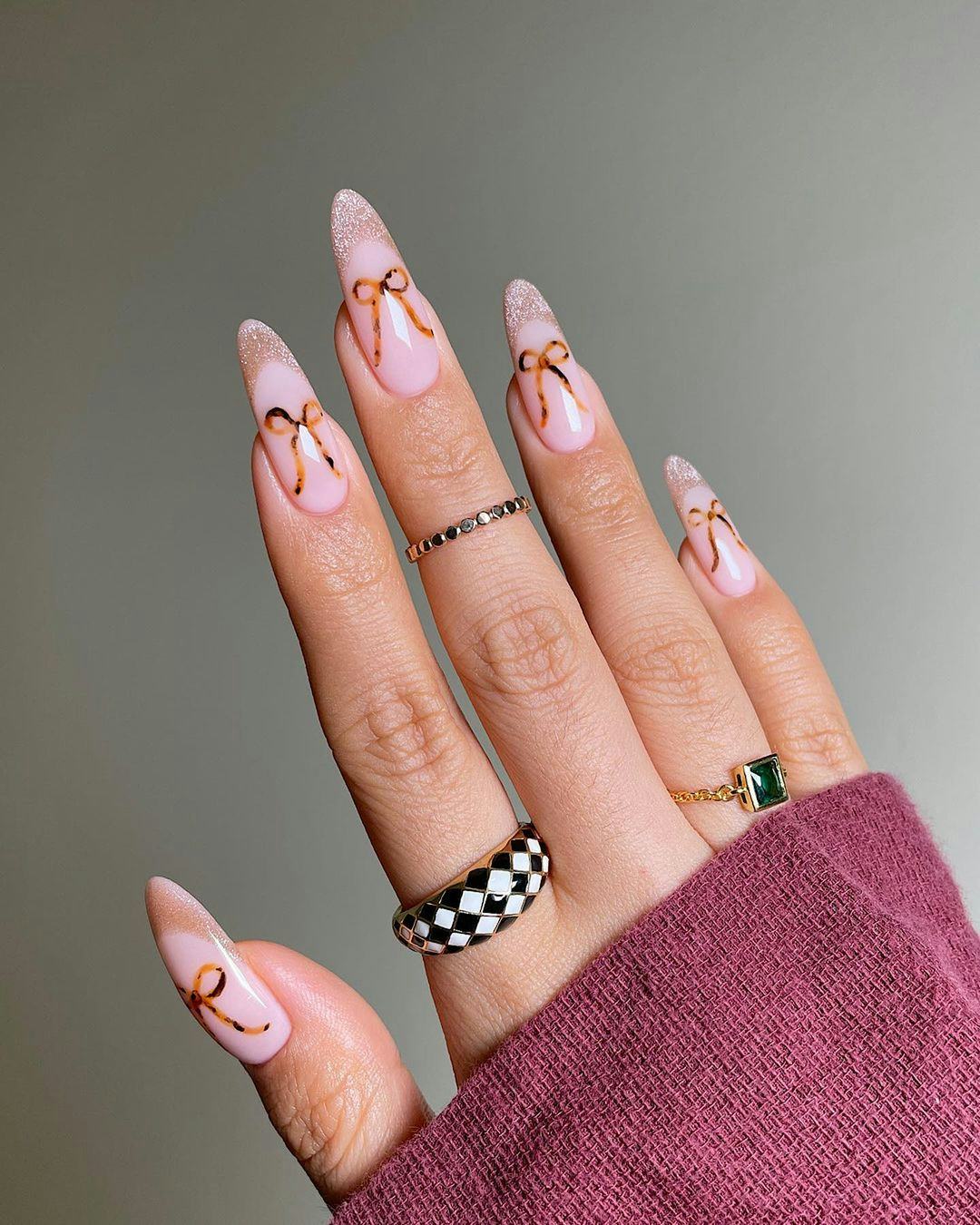 Tortoiseshell printed ribbons on brown French tip nails are an on-trend Capricorn nail design idea f&hellip;