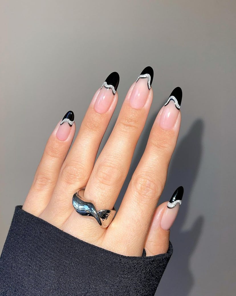 Black and silver French tip nails are an on-trend Capricorn nail design for 2024.