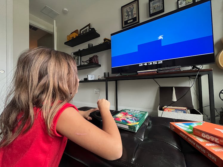 Child playing Atari 2600+ game console