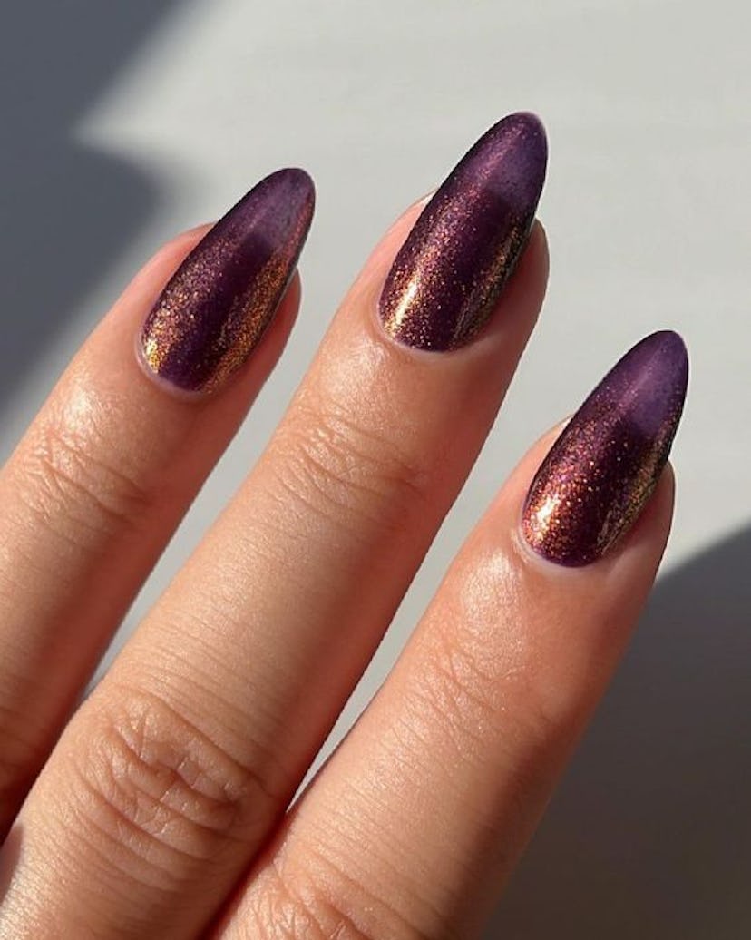 One of the most popular winter nail polish color trends for 2024 is glittering plum.