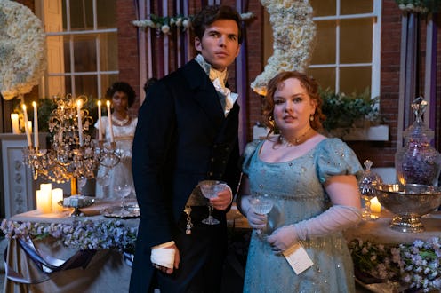 Bridgerton. (L to R) Luke Newton as Colin Bridgerton, Nicola Coughlan as Penelope Featherington in e...