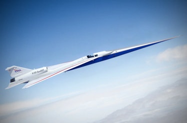 A plane with a needle-shaped nose cone flies high above a shore.