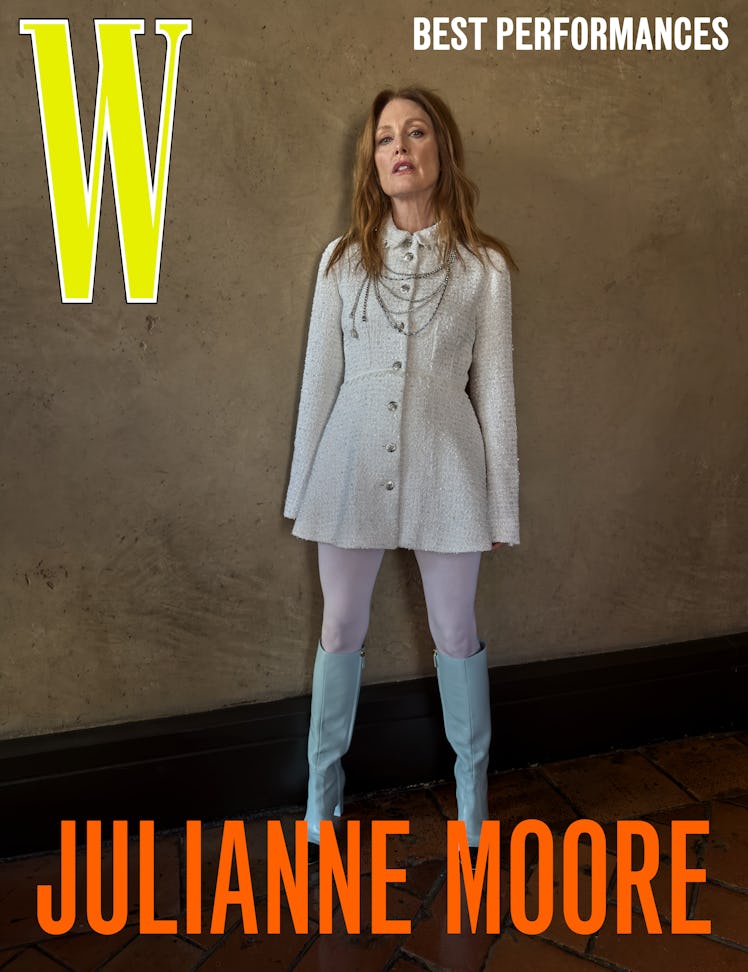 Moore wears a Chanel jacket, tights, and boots; Chanel High Jewelry necklace.
