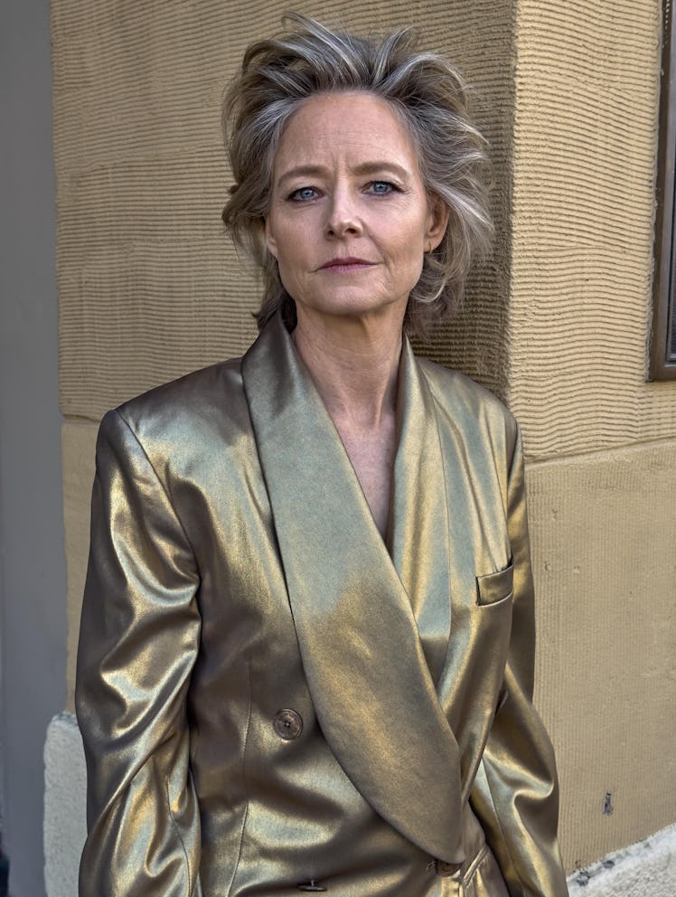 Jodie Foster wears a gold silk blazer.