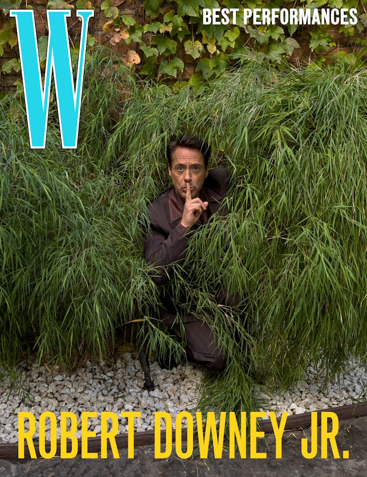 Robert Downey Jr. wears a Burberry jacket, shirt, and pants; his own shoes.