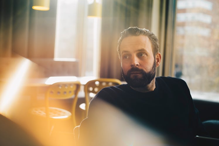 Man sitting in room looking worried