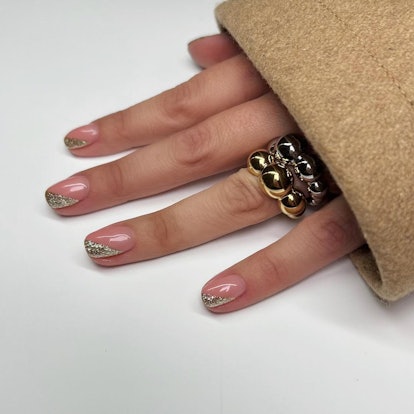 Simple gold glitter nail art on any length or shape is a festive holiday nail design for short nails...