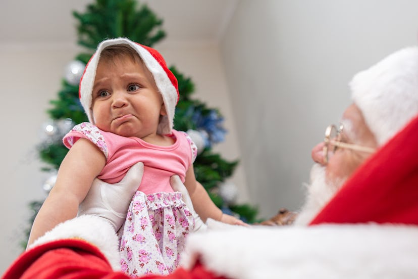 Baby frowns at Santa, in a story about how to prepare your kids to meet Santa.