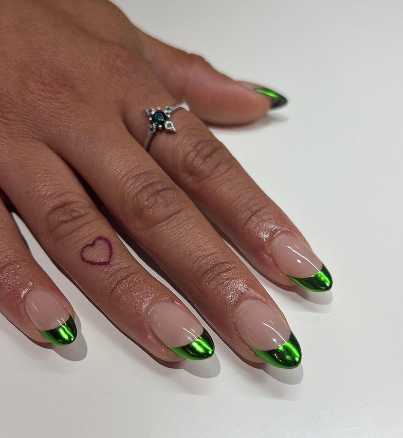 Great for short nails, green chrome French tip nails are a simple & festive holiday nail design for ...