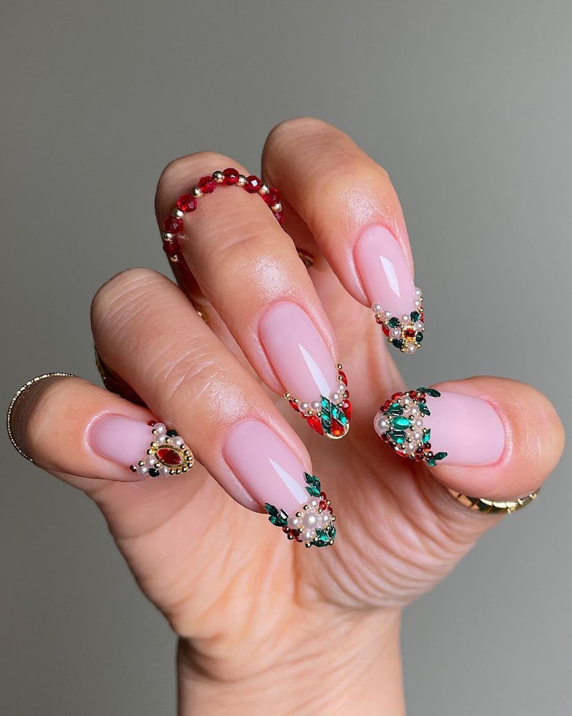 For a simple Christmas nail design for the 2023 holiday season, bedazzled pearl French tip nails are...