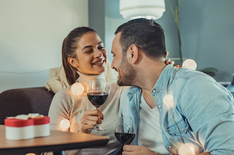 Happy couple enjoying wine during a date night at home