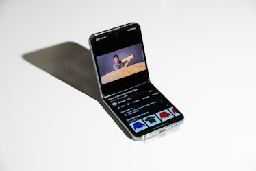 The Galaxy Z Flip 5 half-open on a table.