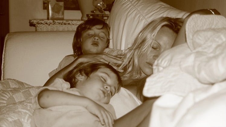 Pamela Anderson asleep with her two sons as young boys.