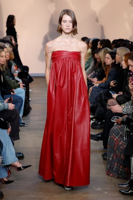 a woman in a red leather gown