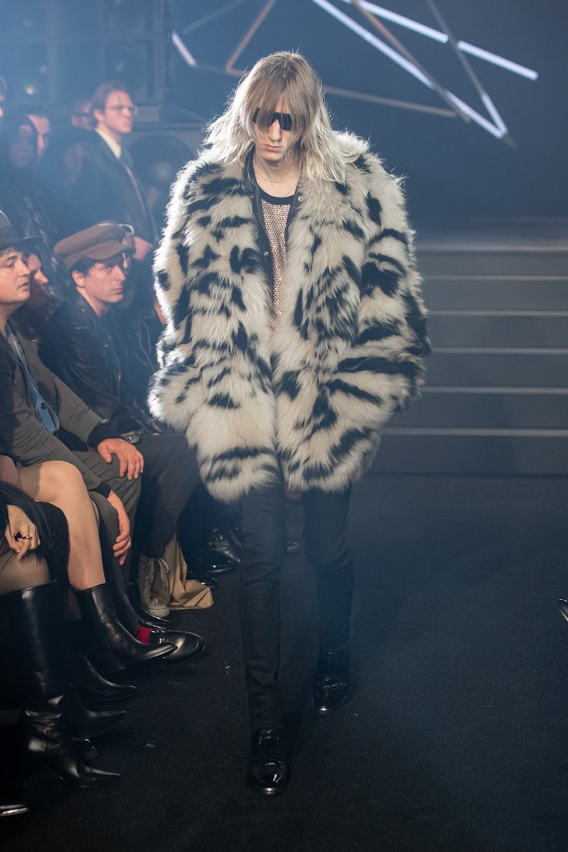 Model in furry striped coat at Celine Homme Fall 2023 show.