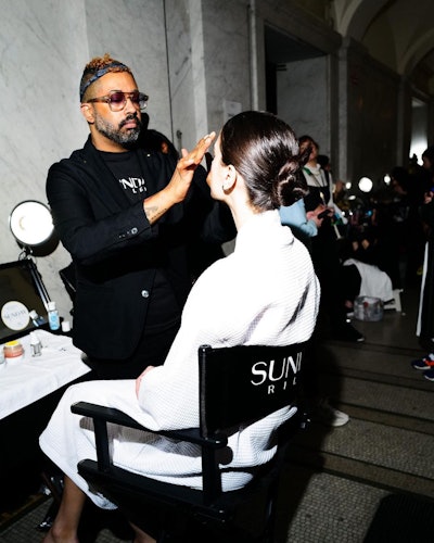 A model getting their makeup done backstage at PatBo F/W '23