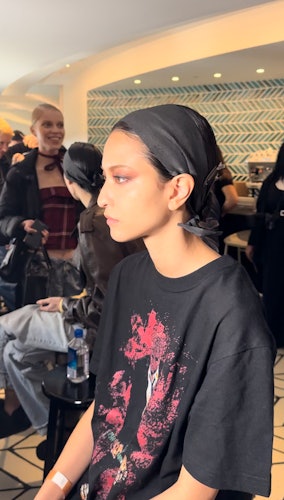 A model getting their makeup done backstage at Jason Wu F/W ‘23
