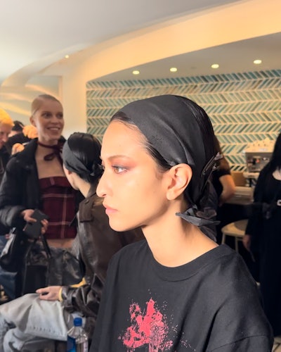 A model getting their makeup done backstage at Jason Wu F/W ‘23