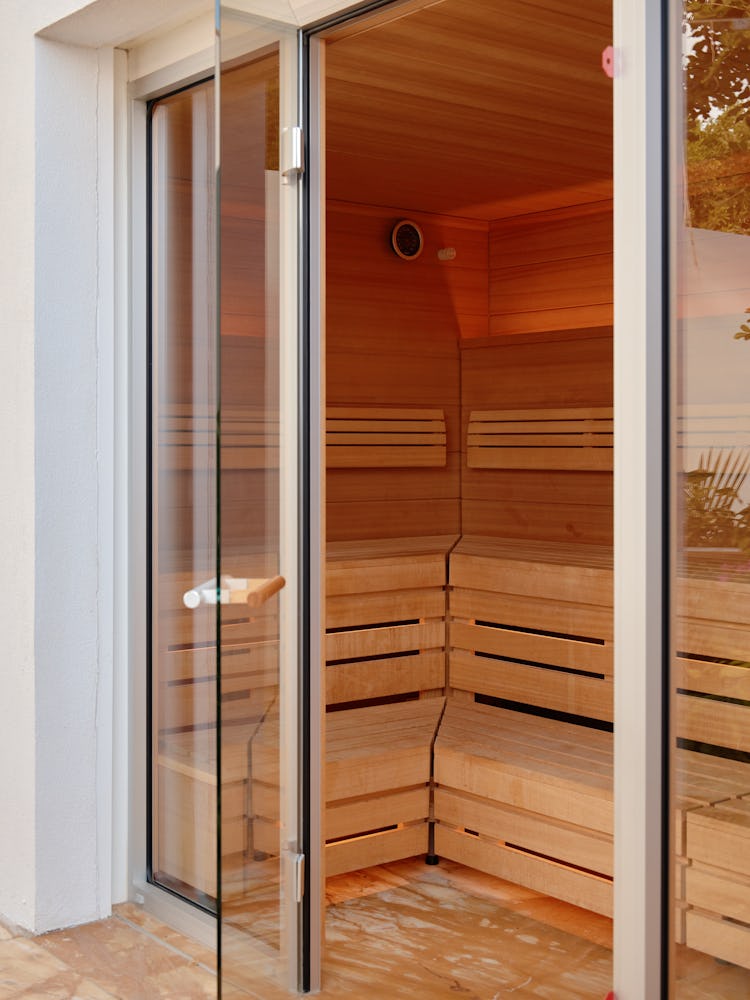 a sauna seen through a partially open glass door