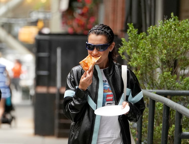 Bella Hadid eating pizza on the streets of NYC