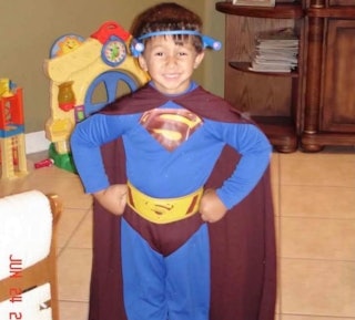 Matt Ramos as a young boy dressed in a Superman costume.