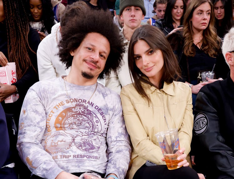 Eric Andre and Emily Ratajkowski sitting with each other at a basketball game
