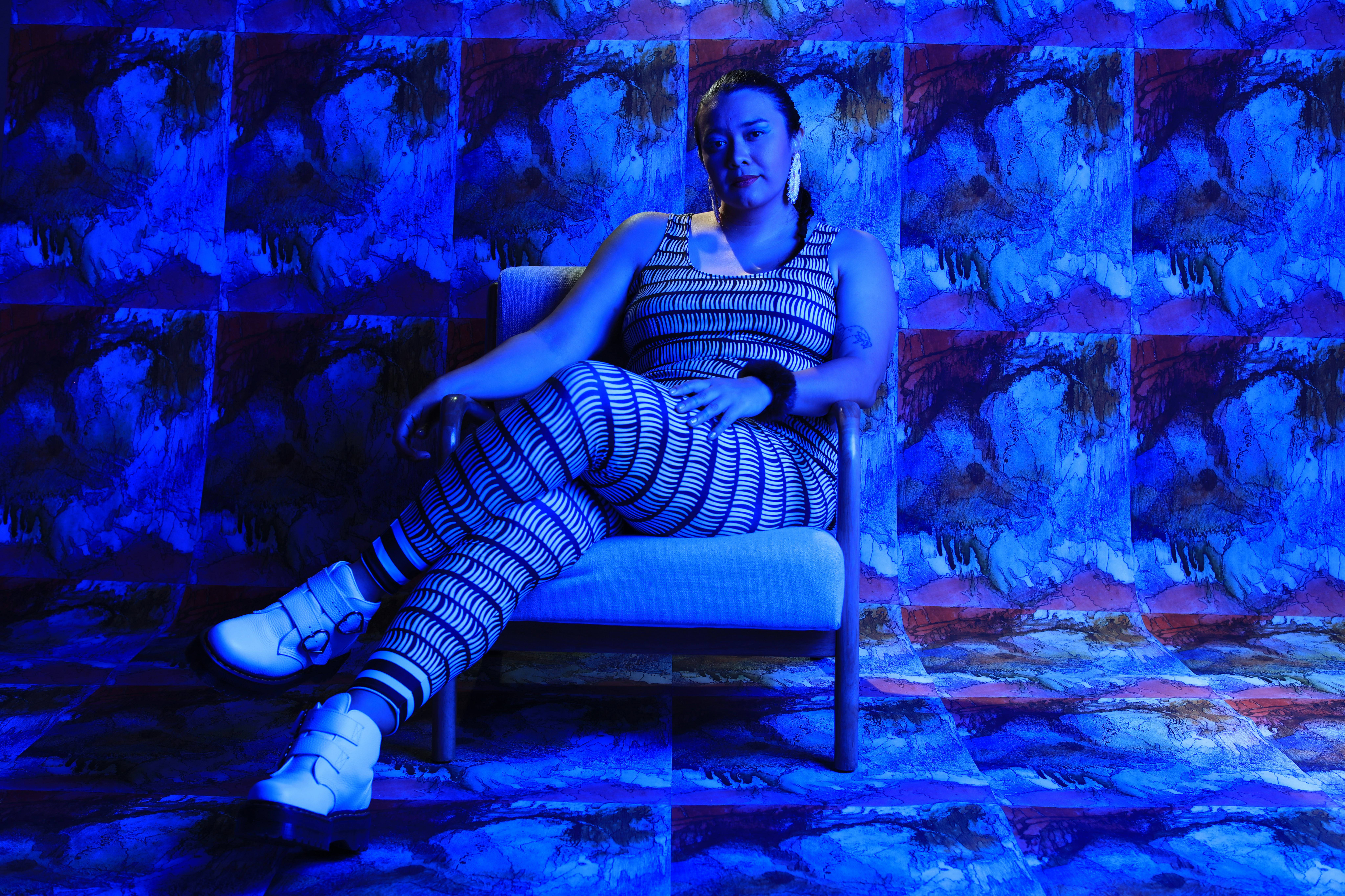 Black Belt Eagle Scout posing under blue light