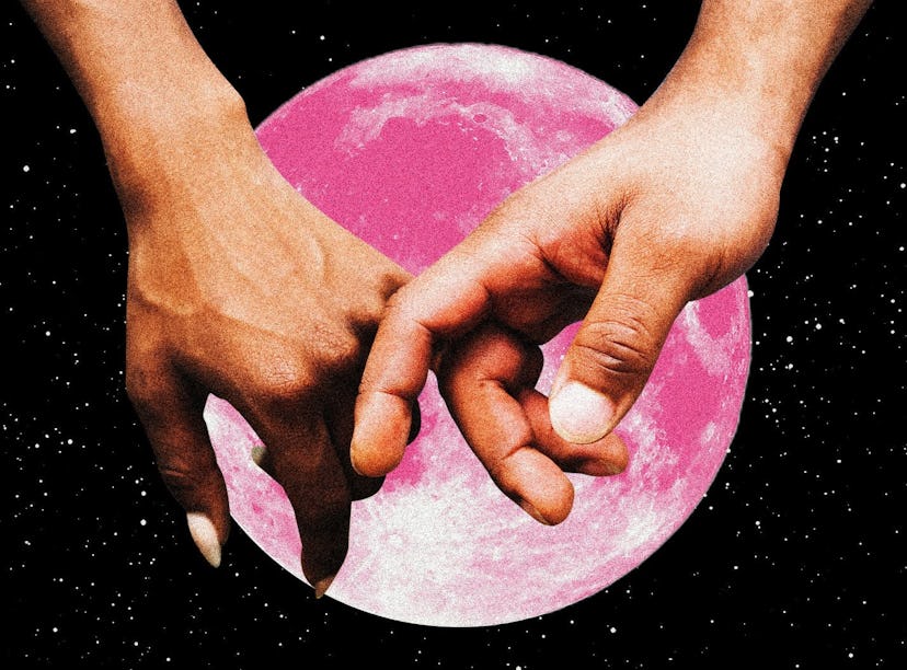 A couple holding hands in front of a pink moon after learning the best day to get married in 2023, a...