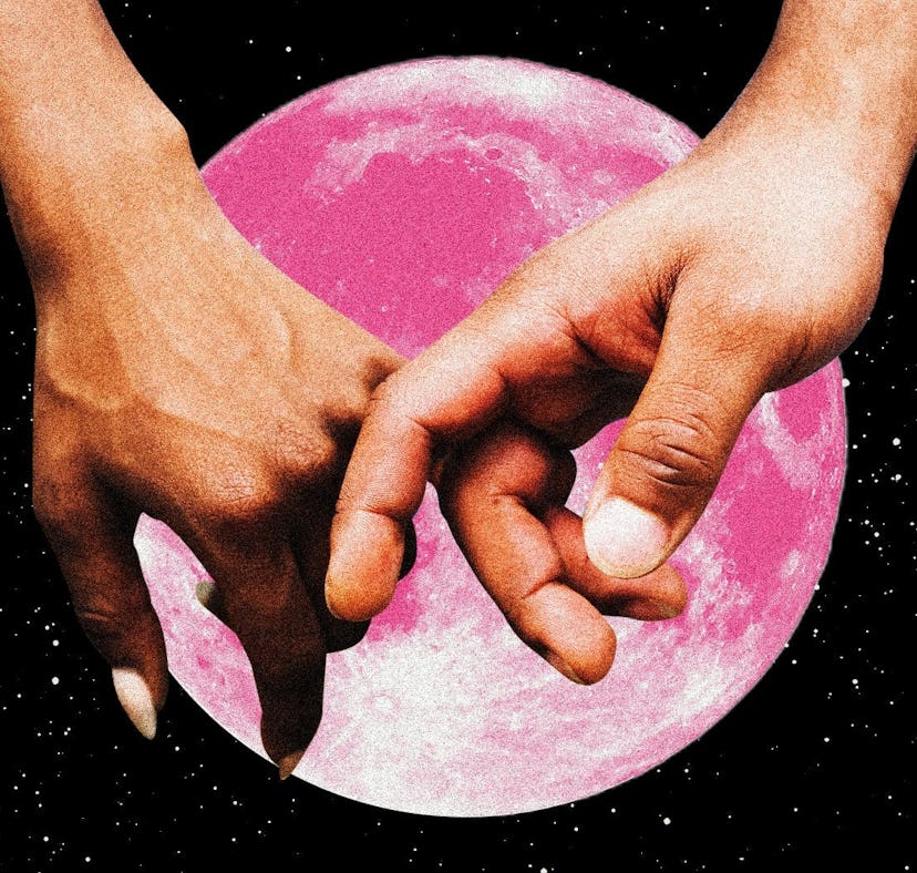 A couple holding hands in front of a pink moon after learning the best day to get married in 2023, a...